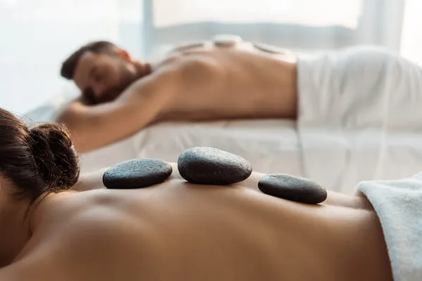 two people in spa receiving back massage